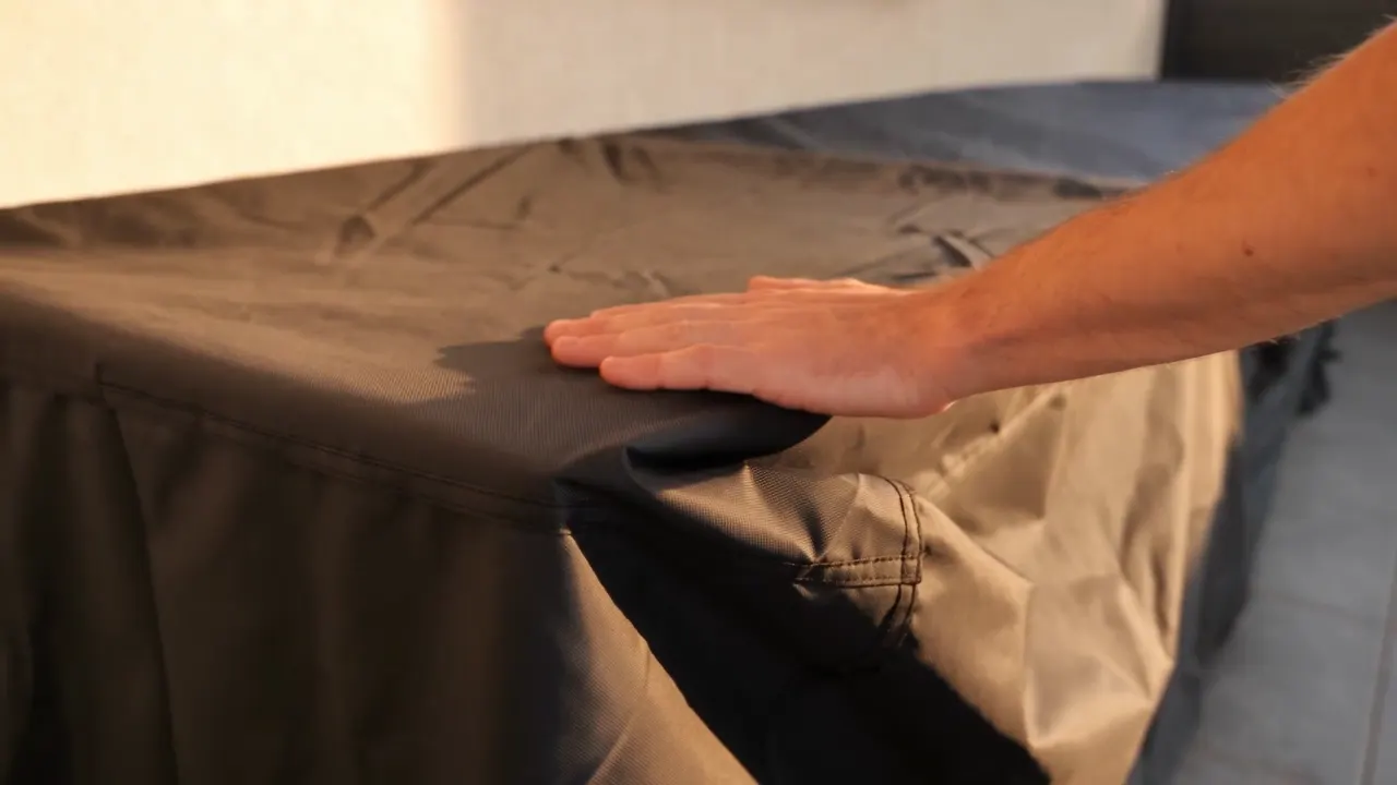 Housse de protection sur mesure MESUROO, posée à la main sur un meuble