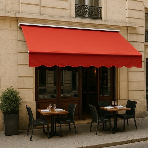 Store banne rouge en toile acrylique Sauleda Masacril sur une façade